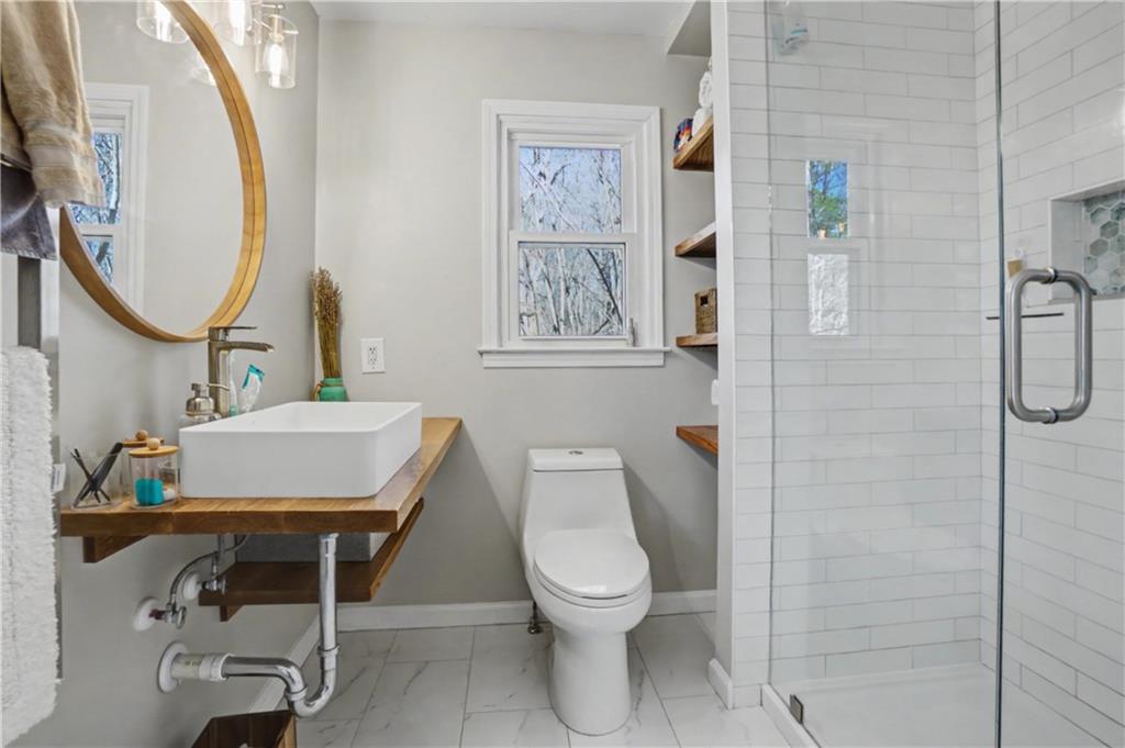 408 Candy Lane Canton, GA 30115 - Photo 14 of 22 a bathroom with a toilet sink and mirror