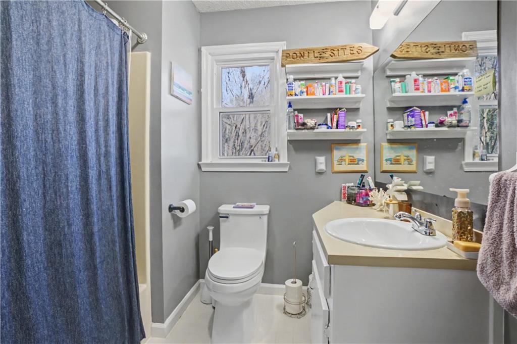 408 Candy Lane Canton, GA 30115 - Photo 16 of 22 a bathroom with a toilet a sink and a shower