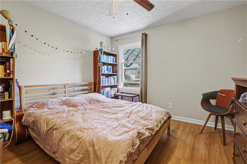 408 Candy Lane Canton, GA 30115 - Photo 17 of 22 a bedroom with a bed a dresser and book shelf
