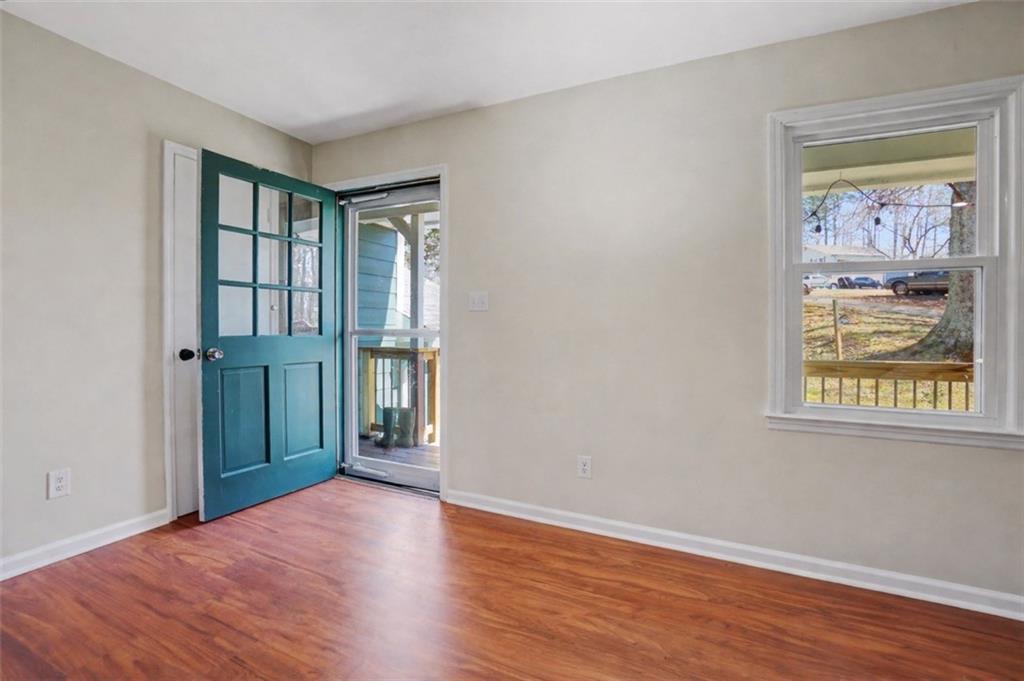 408 Candy Lane Canton, GA 30115 - Photo 3 of 22 a view of an empty room with wooden floor and a window