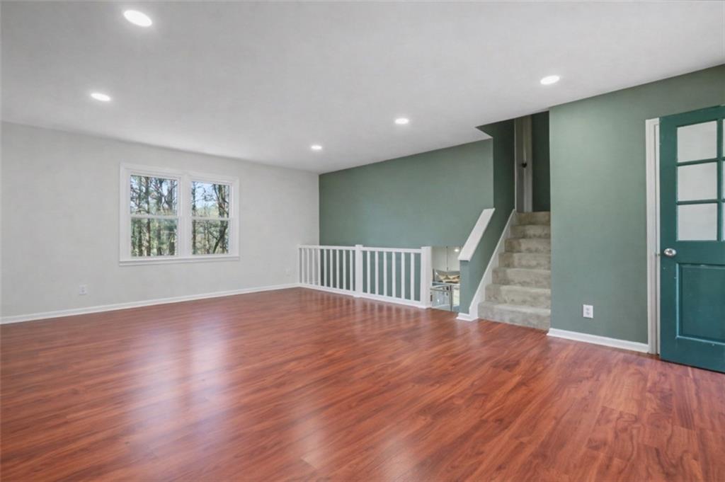 408 Candy Lane Canton, GA 30115 - Photo 5 of 22 a view of an empty room with wooden floor and a window
