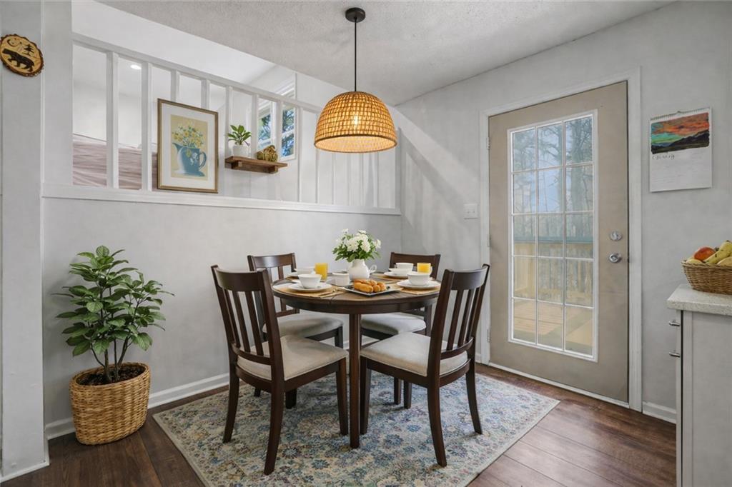 408 Candy Lane Canton, GA 30115 - Photo 6 of 22 a dining room with furniture potted plants and wooden floor