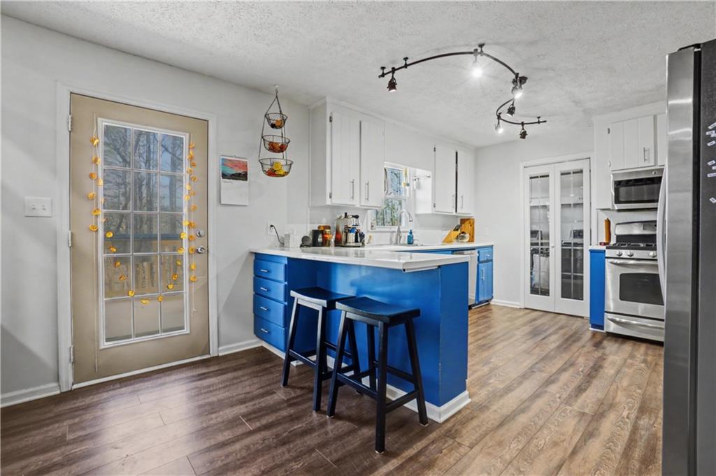 408 Candy Lane Canton, GA 30115 - Photo 7 of 22 a dining room with stainless steel appliances a dining table chairs and wooden floor