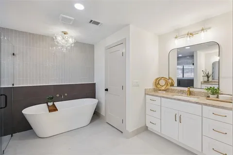 a kitchen with white cabinets and sink
