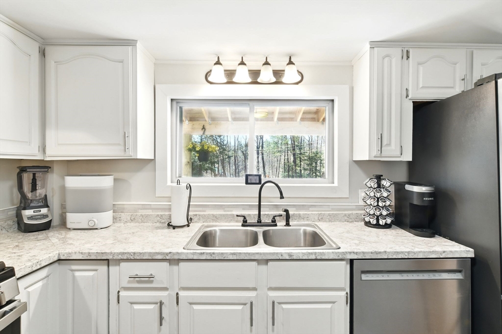 24 Old Main Road Worthington, MA 01098 - Photo 19 of 42 a kitchen with granite countertop a sink and a window