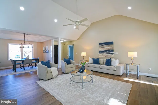 a dining room with wooden floor a chandelier