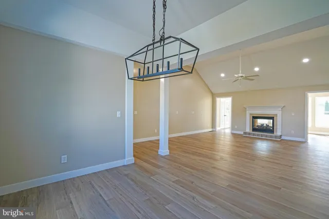 a view of a room with wooden floor and window