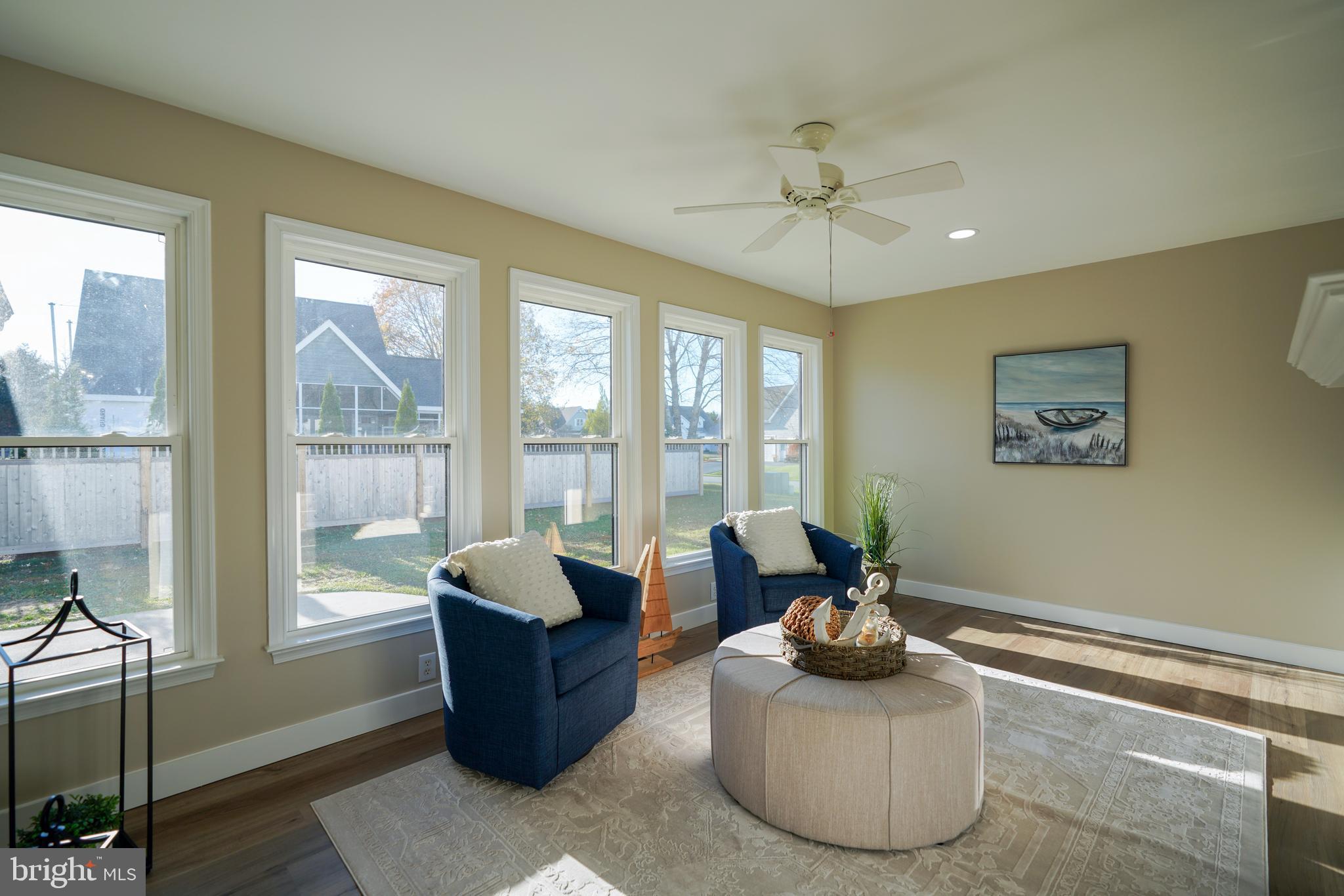 32911 Nassau Loop Lewes, DE 19958 - Photo 29 of 56 a living room with furniture and a floor to ceiling window