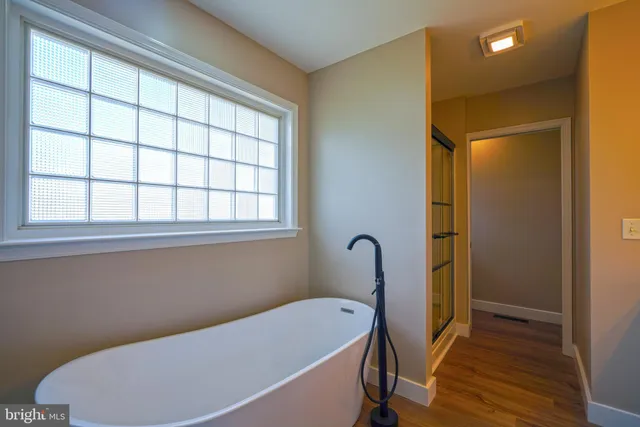 a bathroom with a bathtub and a window