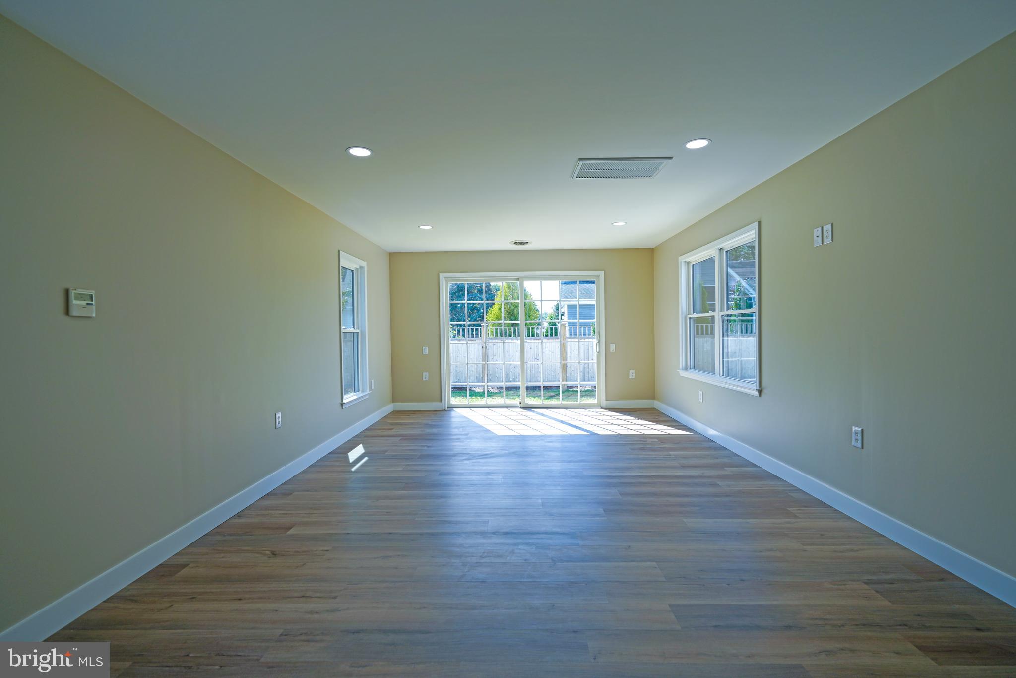 32911 Nassau Loop Lewes, DE 19958 - Photo 35 of 56 a view of empty room with wooden floor and fan
