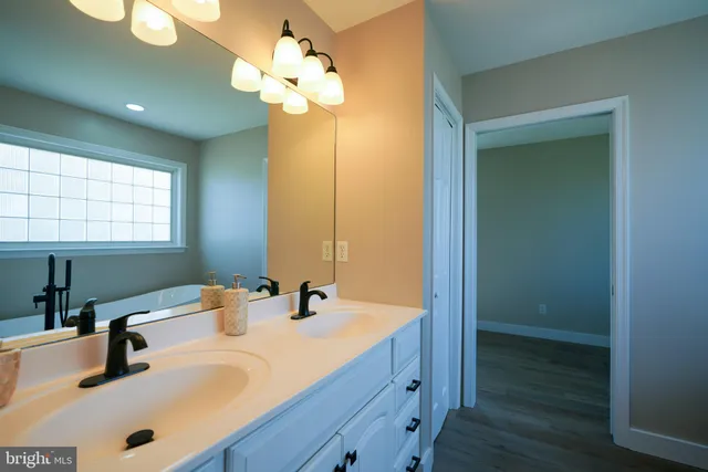 a bathroom with a double vanity sink and a mirror