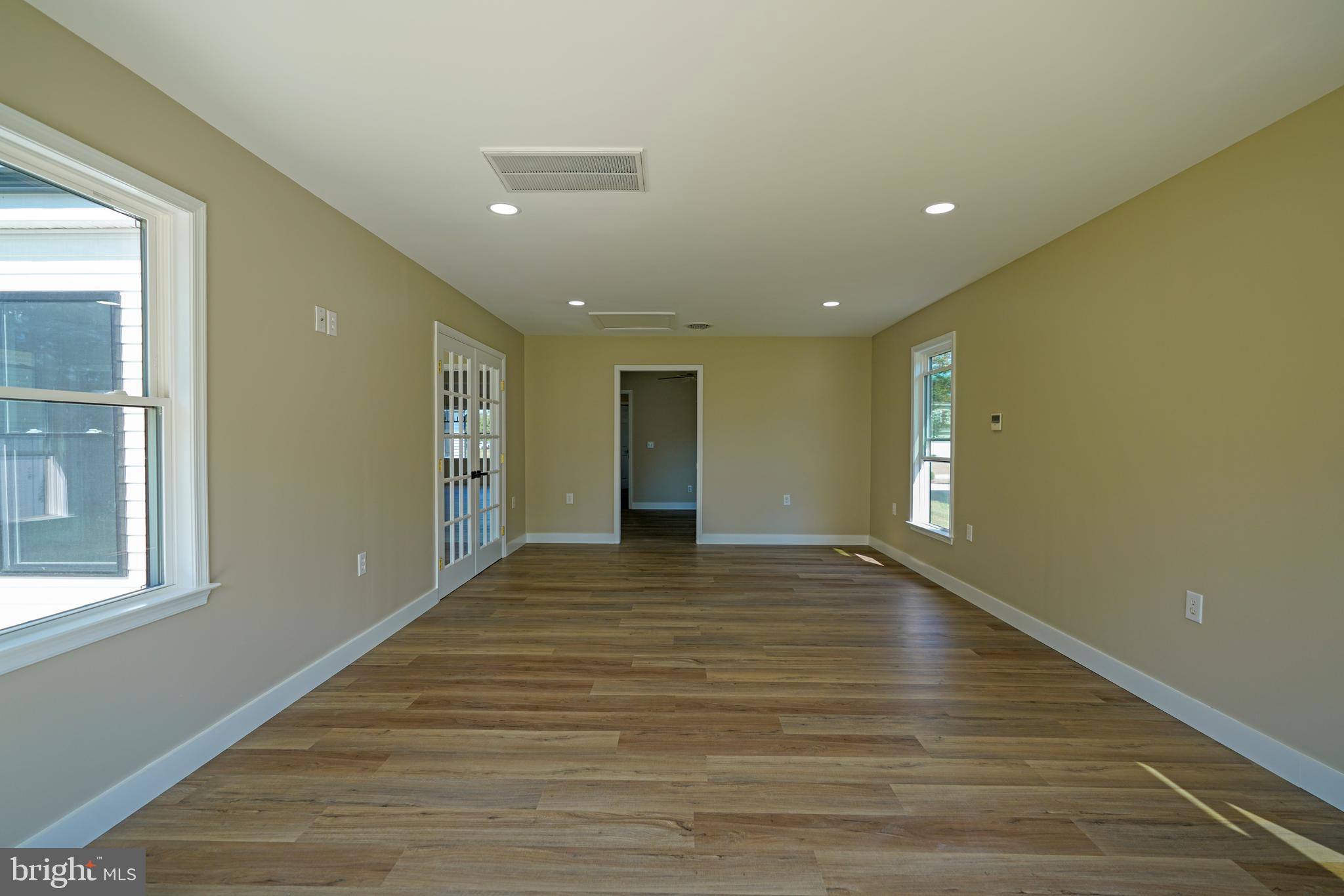 32911 Nassau Loop Lewes, DE 19958 - Photo 37 of 56 a view of an empty room with wooden floor and a window