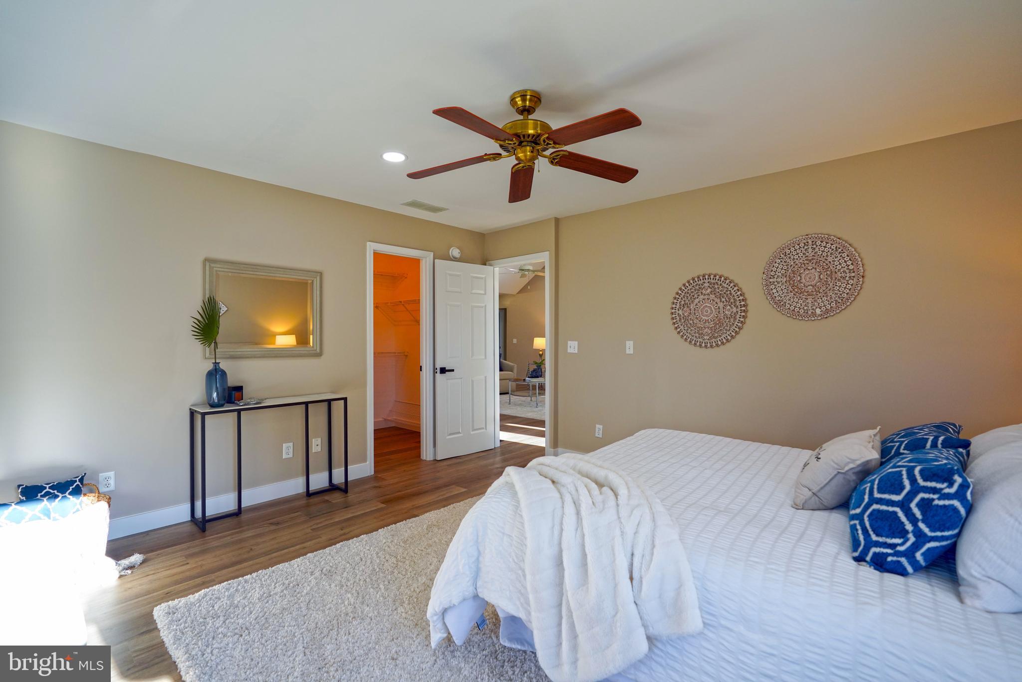 32911 Nassau Loop Lewes, DE 19958 - Photo 39 of 56 a bedroom with a bed and painting on the wall