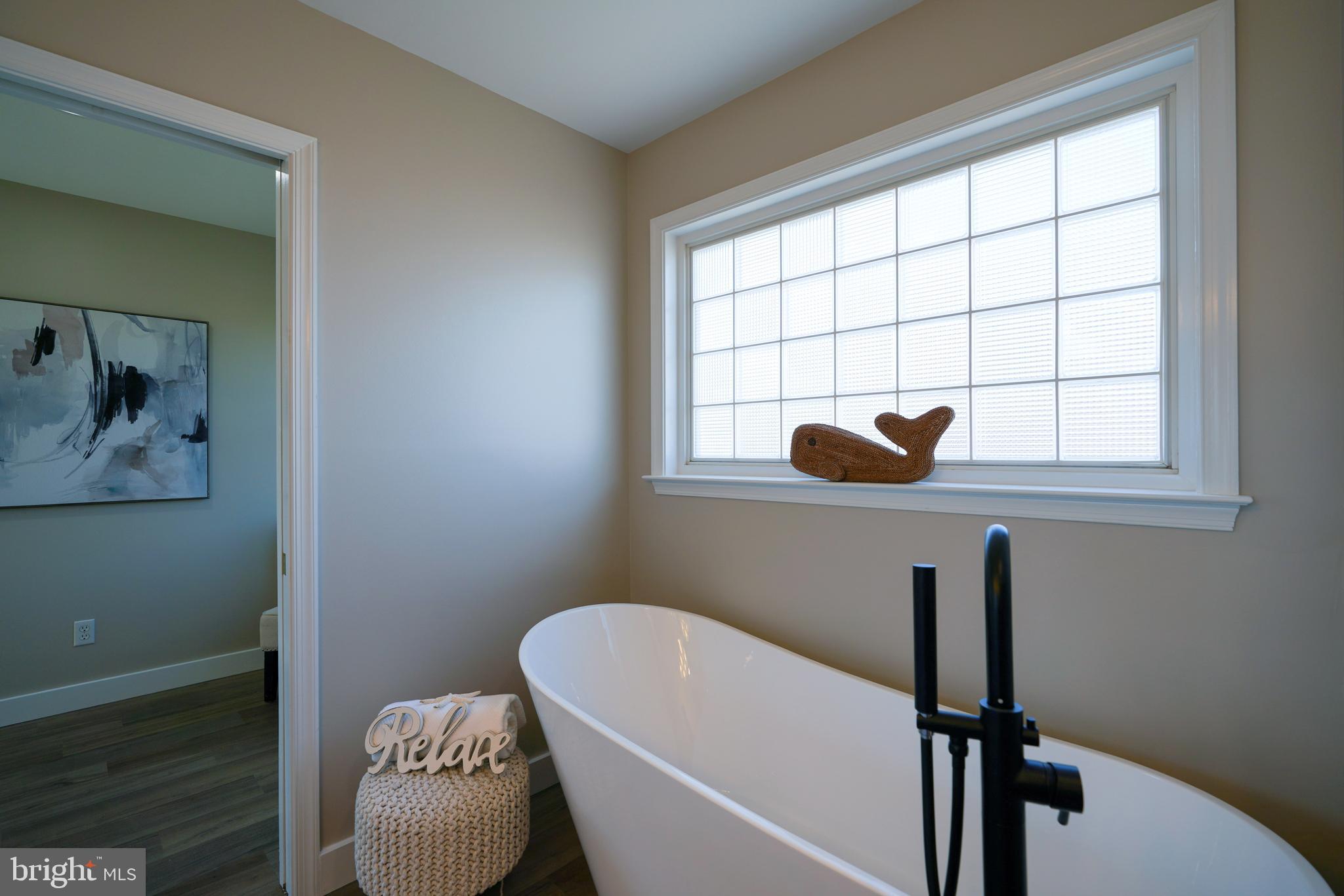 32911 Nassau Loop Lewes, DE 19958 - Photo 43 of 56 a bathroom with a tub and a window