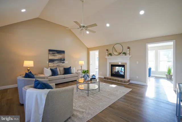 a living room with furniture a fireplace and a chandelier