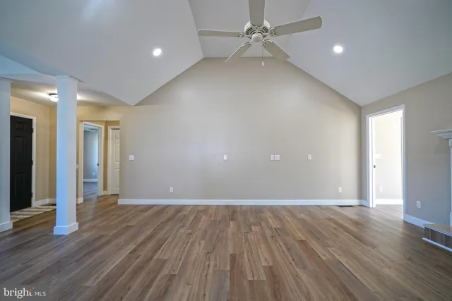 a view of an empty room with wooden floor