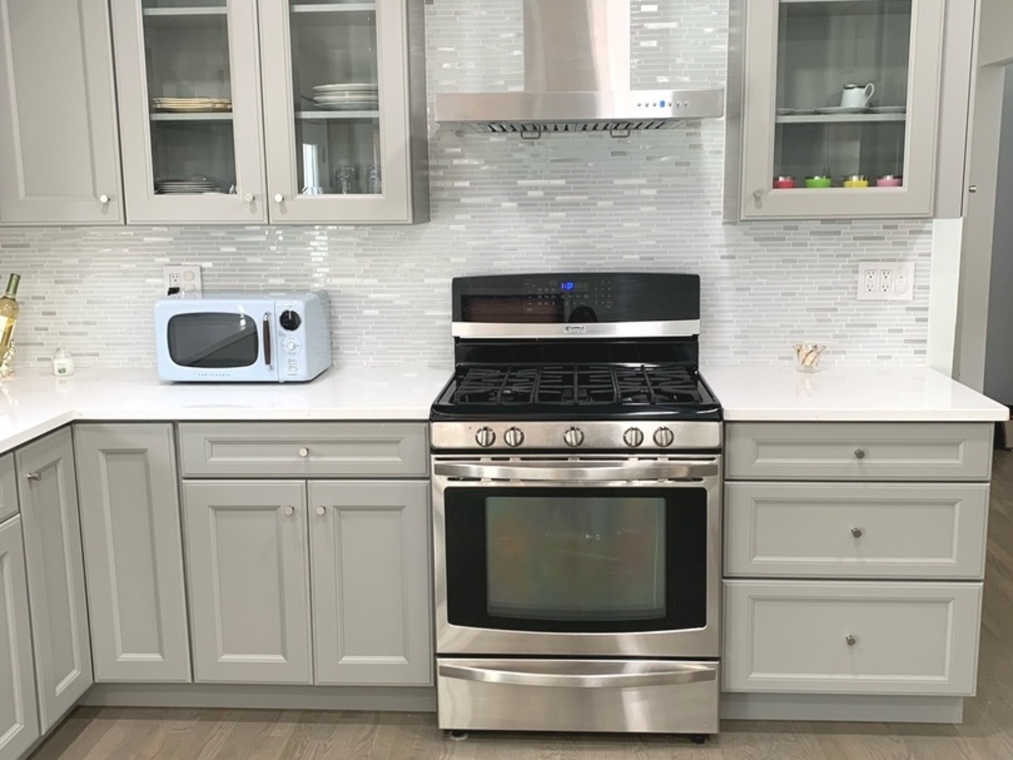 Undisclosed Address Mount Prospect, IL 60056 - Photo 13 of 14 a stove top oven sitting inside of a kitchen and white cabinets