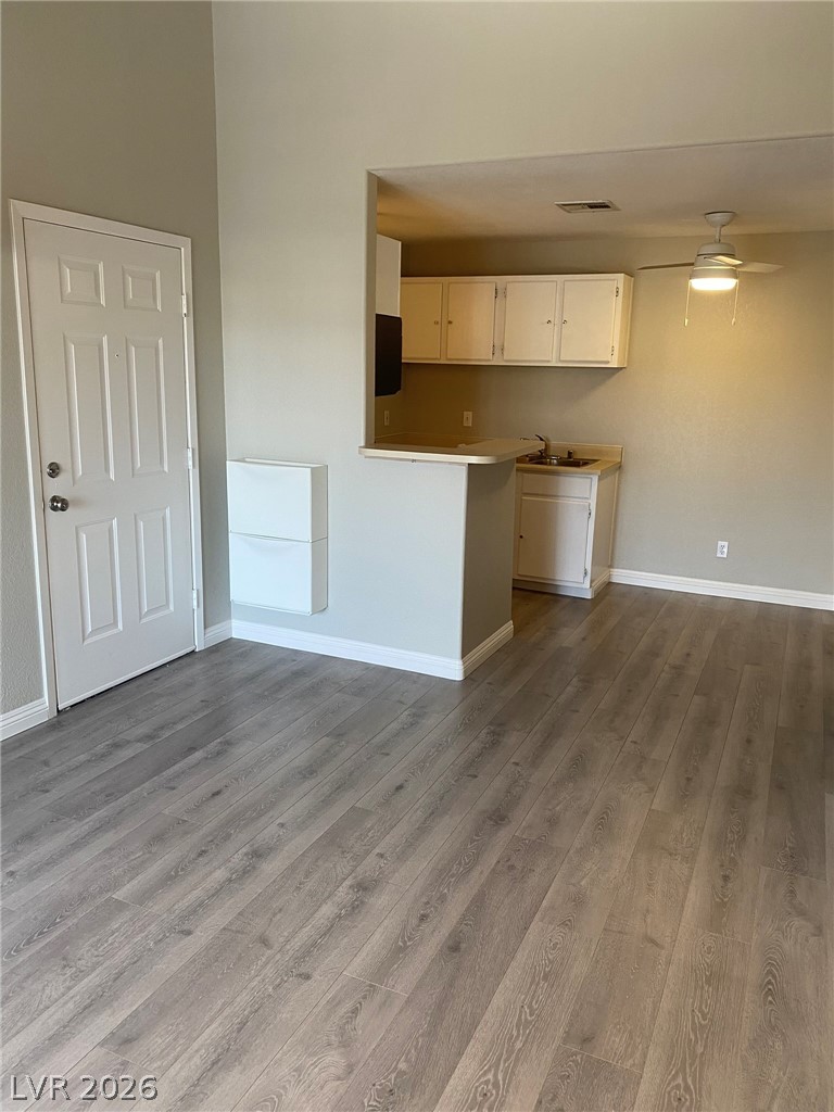 5271 South Lindell Road, Unit 202 Las Vegas, NV 89118 - Photo 10 of 27 A well-lit, open-concept area featuring durable laminate flooring and a kitchen pass-through.