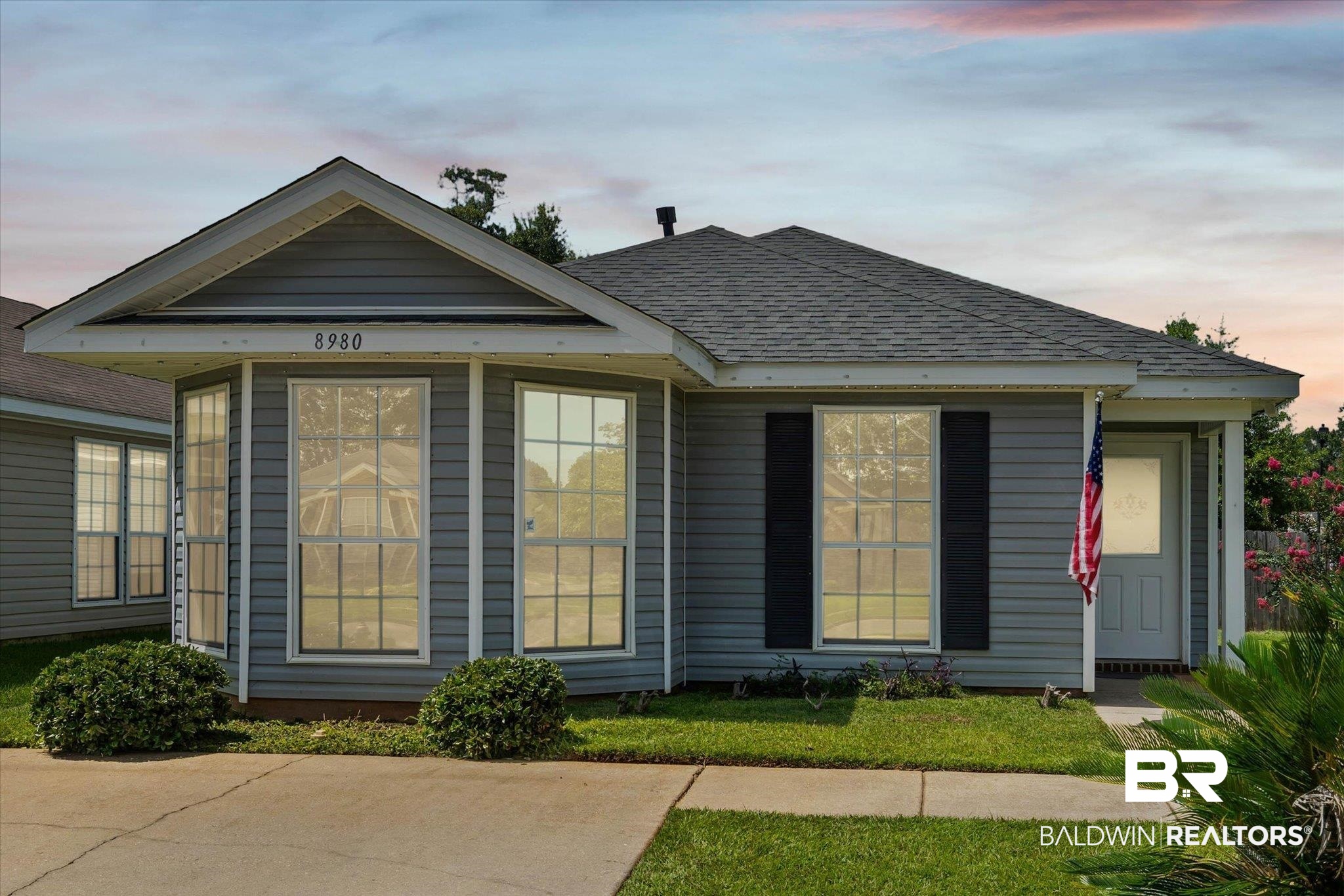 8980 Spring Grove North Mobile, AL 36695 - Photo 1 of 24 Single-story residence featuring grey horizontal siding and a dark shingle roof