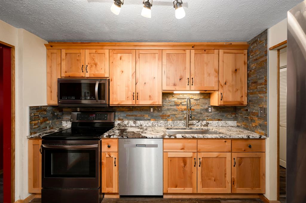 201 Colleen Street Butler, PA 16001 - Photo 11 of 33 a kitchen with stainless steel appliances granite countertop a stove a sink and a microwave