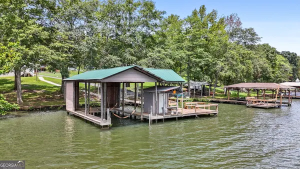 a view of a lake with boats and trees in the background