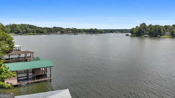 a view of a lake with houses in the back