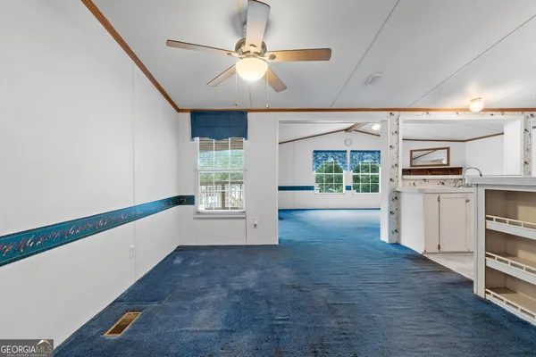 a view of a livingroom with an empty space and a fireplace
