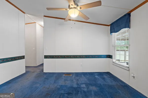 an empty room with wooden floor and fireplace