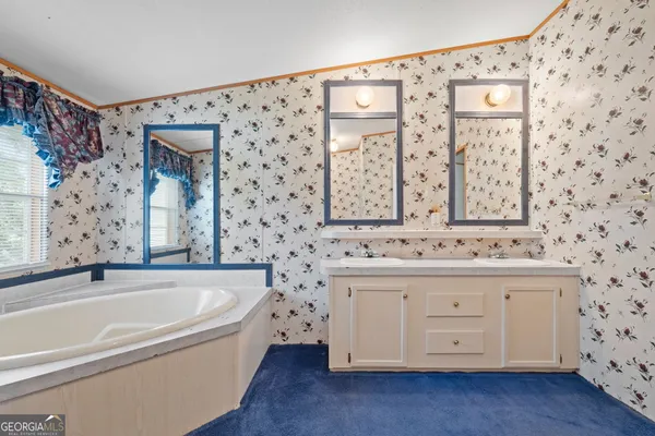 an empty room with a window and ceiling fan