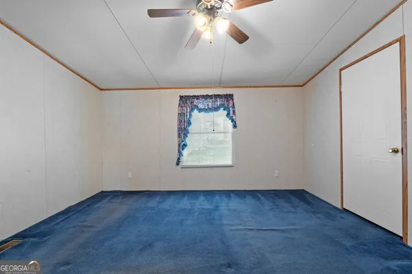 a view of empty room with window and fireplace
