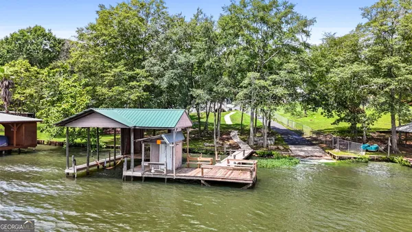 a backyard of a house with yard table and chairs