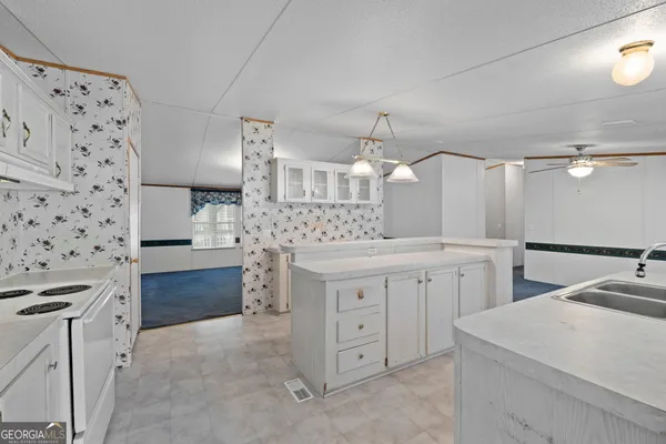 a kitchen with cabinets appliances and a counter space