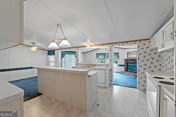 a kitchen with stainless steel appliances granite countertop a sink a stove and a refrigerator