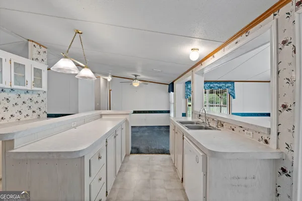a bathroom with a sink vanity granite tub and shower