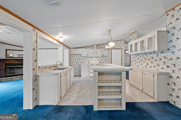 a kitchen with cabinets and wooden floor