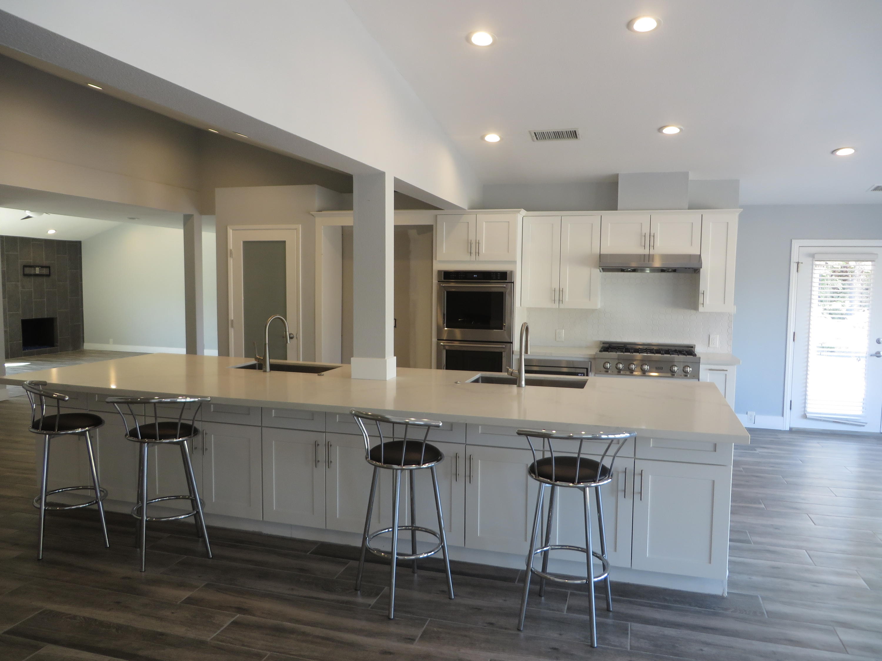 73315 Haystack Road Palm Desert, CA 92260 - Photo 11 of 32 a kitchen with cabinets a sink and chairs in it