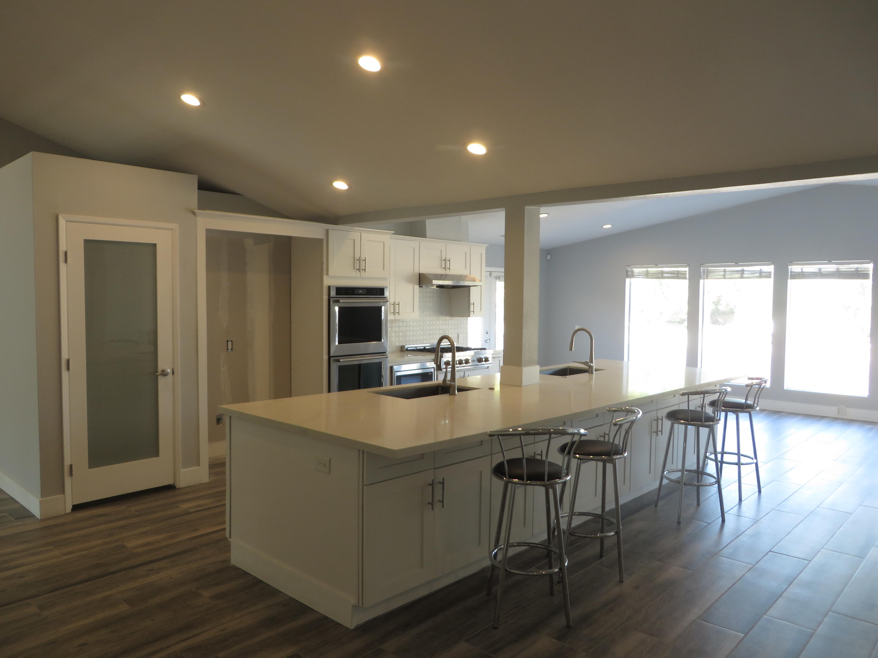 73315 Haystack Road Palm Desert, CA 92260 - Photo 12 of 32 a large kitchen with kitchen island a large counter top space a sink stainless steel appliances and cabinets