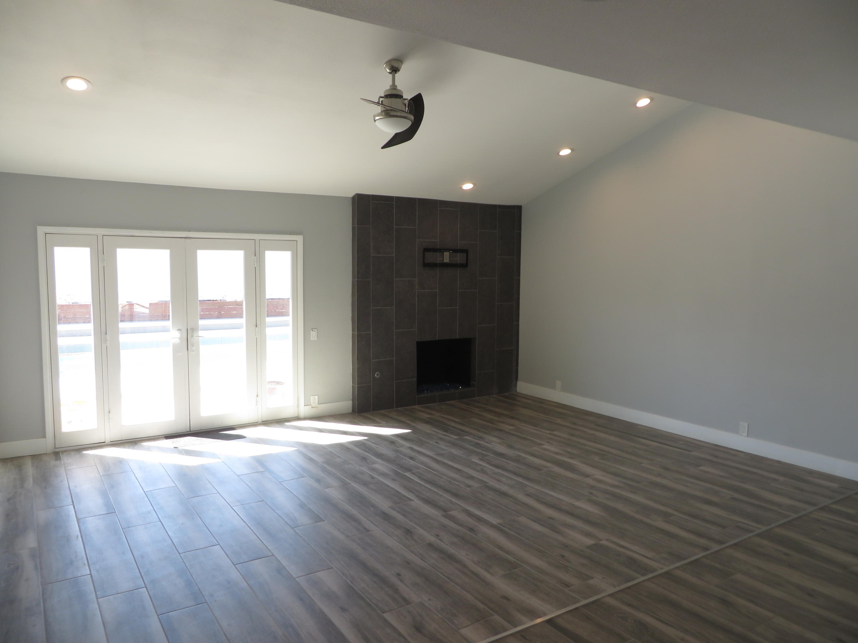 73315 Haystack Road Palm Desert, CA 92260 - Photo 15 of 32 a view of an empty room with a window and wooden floor