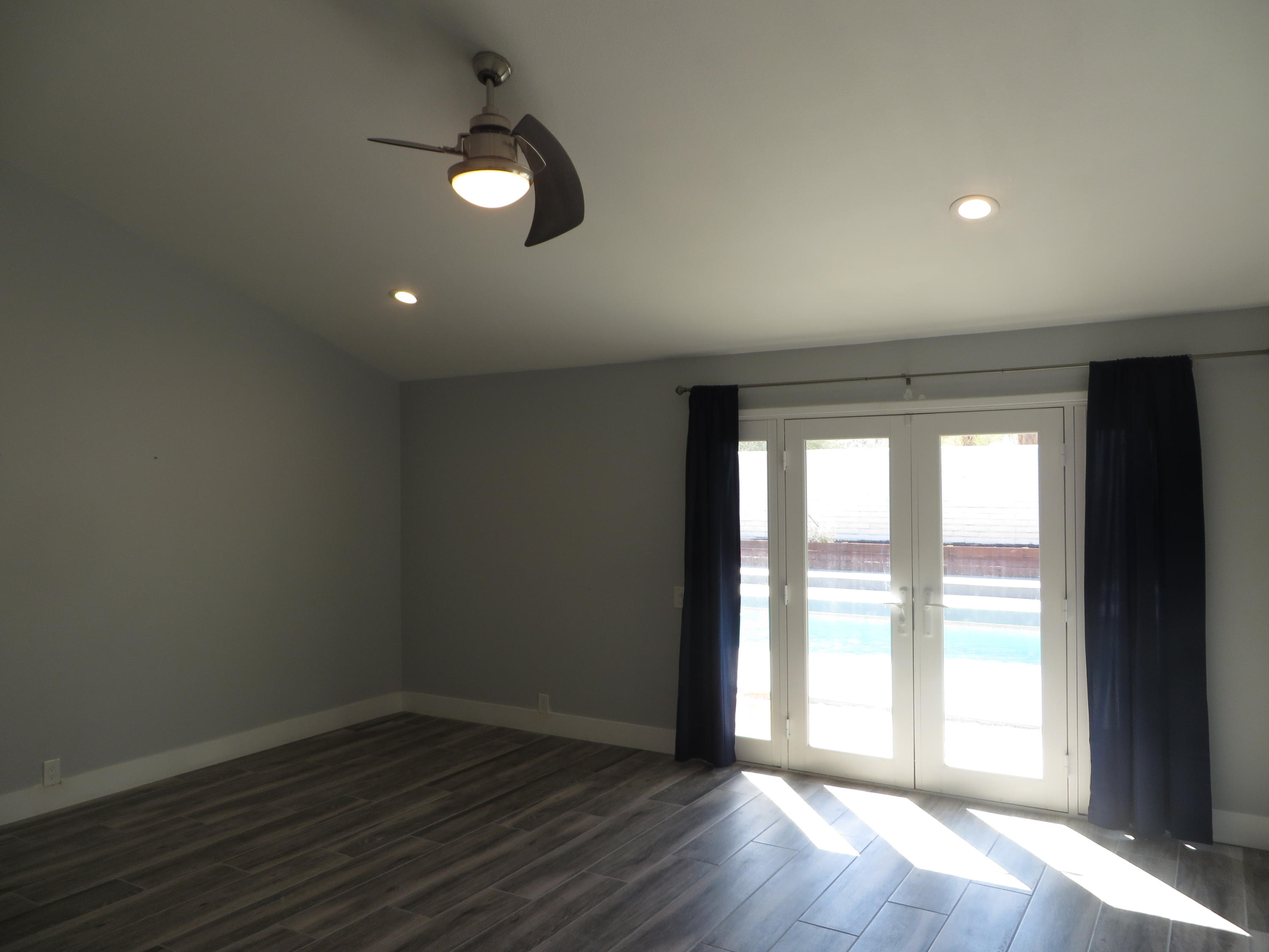 73315 Haystack Road Palm Desert, CA 92260 - Photo 16 of 32 an empty room with wooden floor and windows