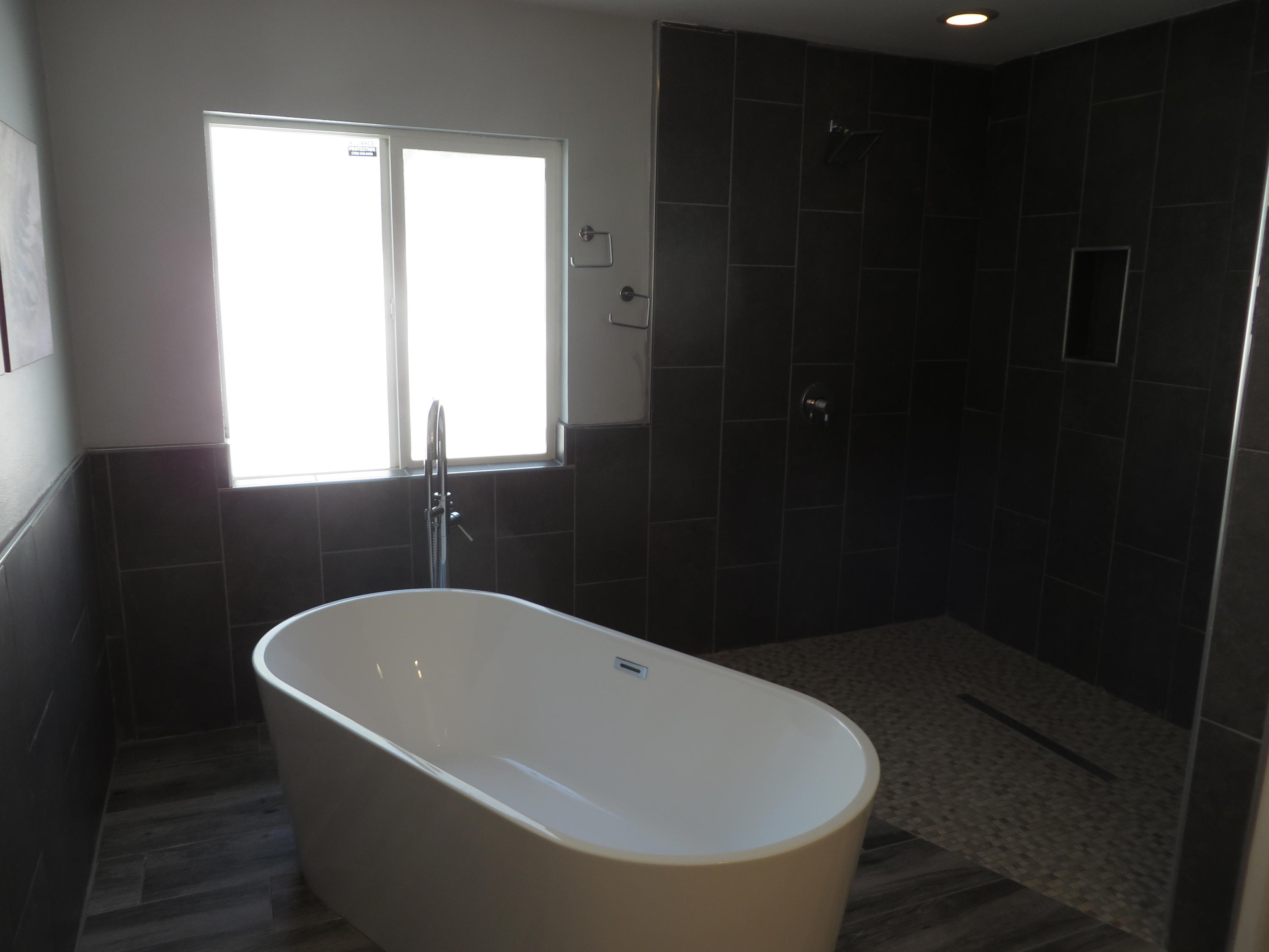 73315 Haystack Road Palm Desert, CA 92260 - Photo 18 of 32 a white bath tub sitting in a bathroom next to a window