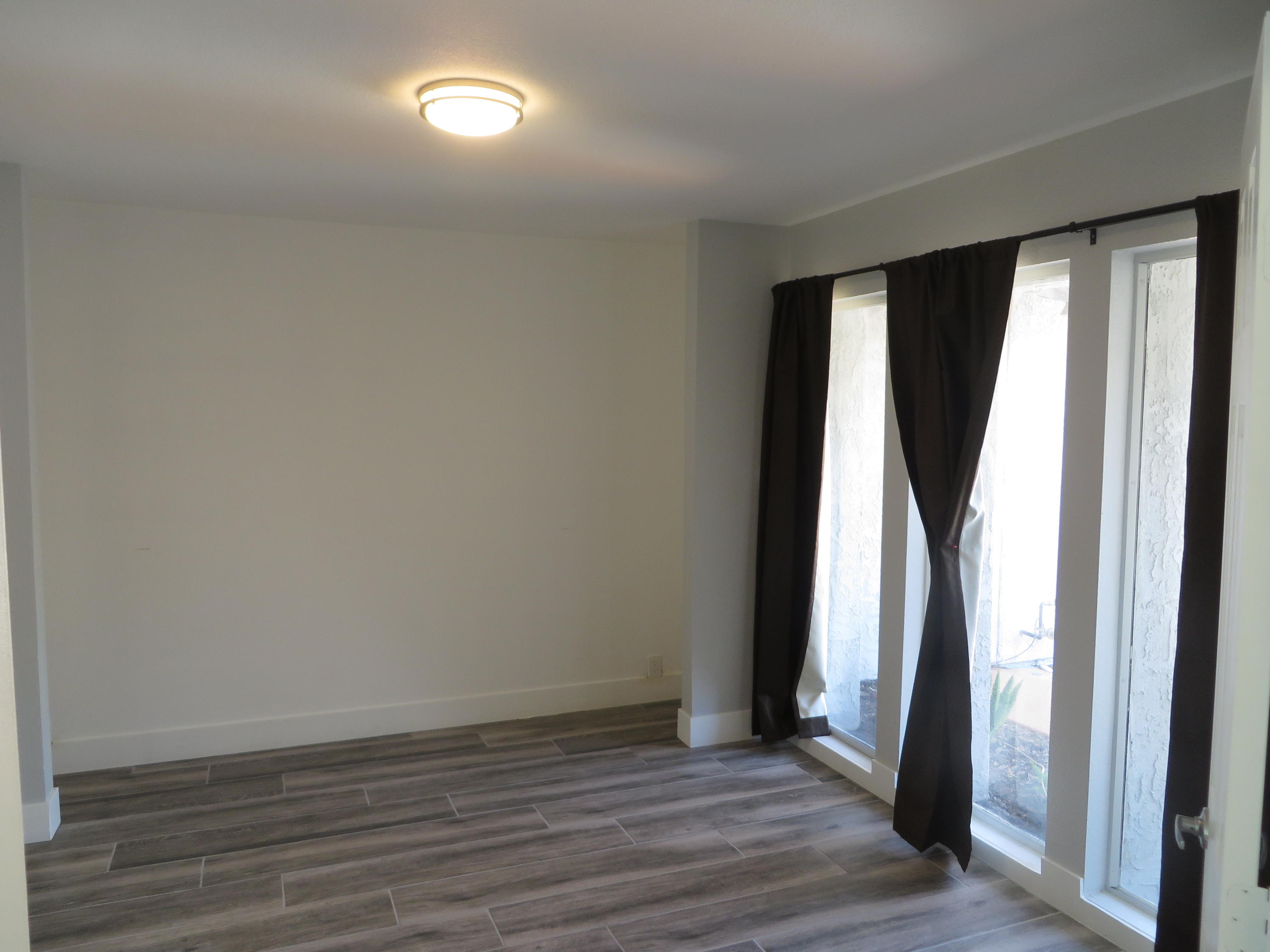 73315 Haystack Road Palm Desert, CA 92260 - Photo 20 of 32 an empty room with wooden floor and a window