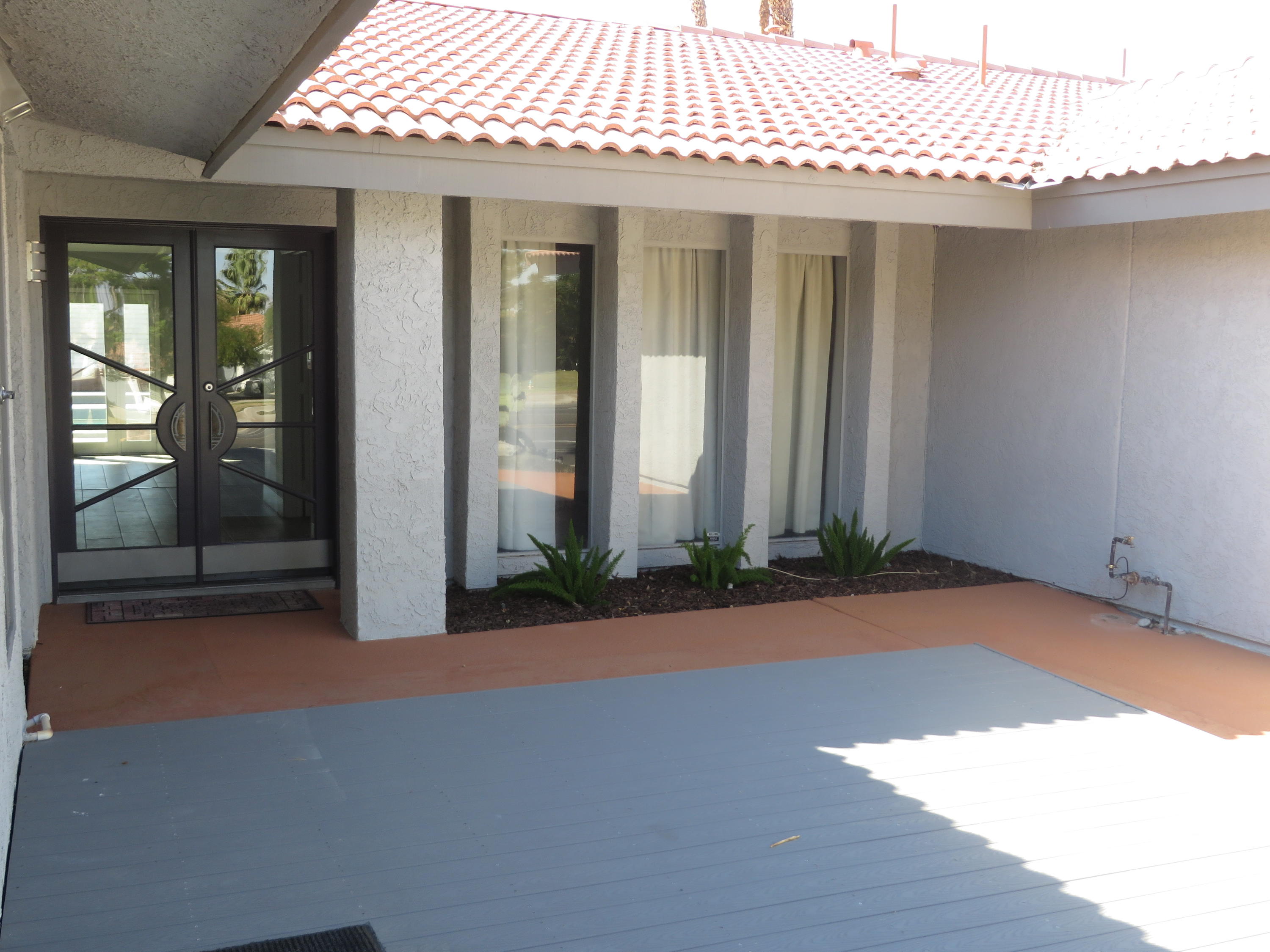 73315 Haystack Road Palm Desert, CA 92260 - Photo 3 of 32 a view of a house with potted plants