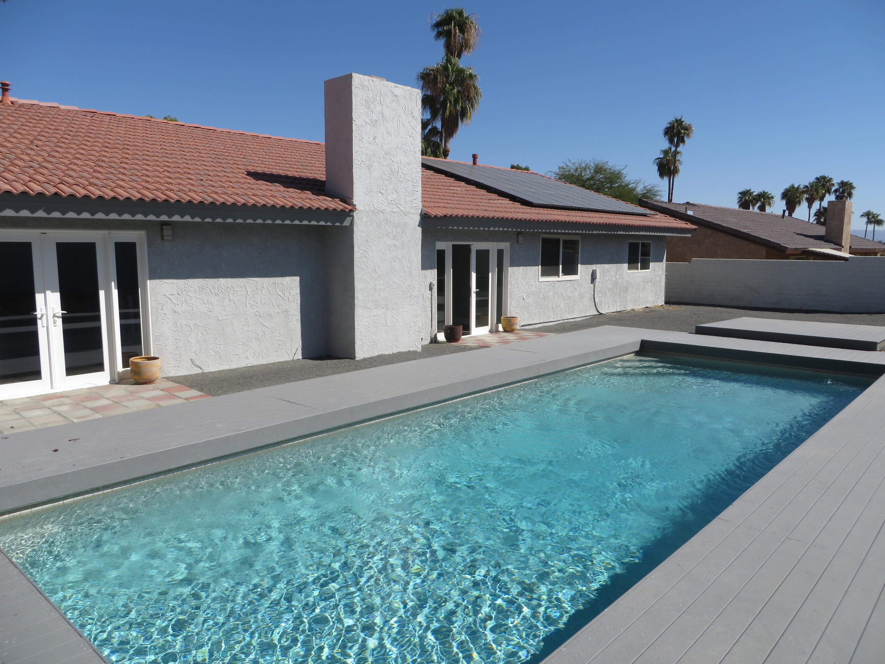 73315 Haystack Road Palm Desert, CA 92260 - Photo 24 of 32 a front view of a house with garden
