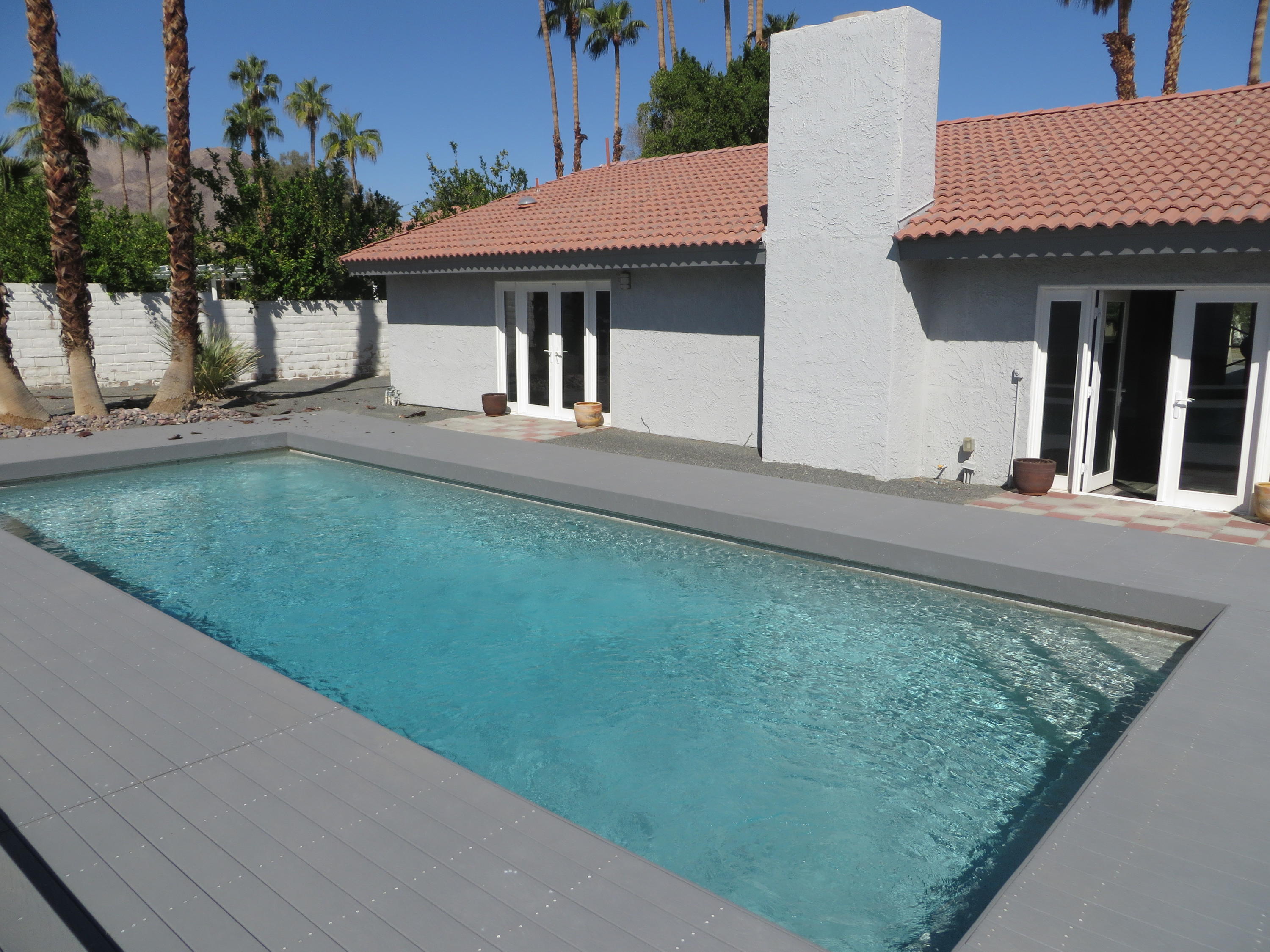 73315 Haystack Road Palm Desert, CA 92260 - Photo 25 of 32 a front view of a house with garden