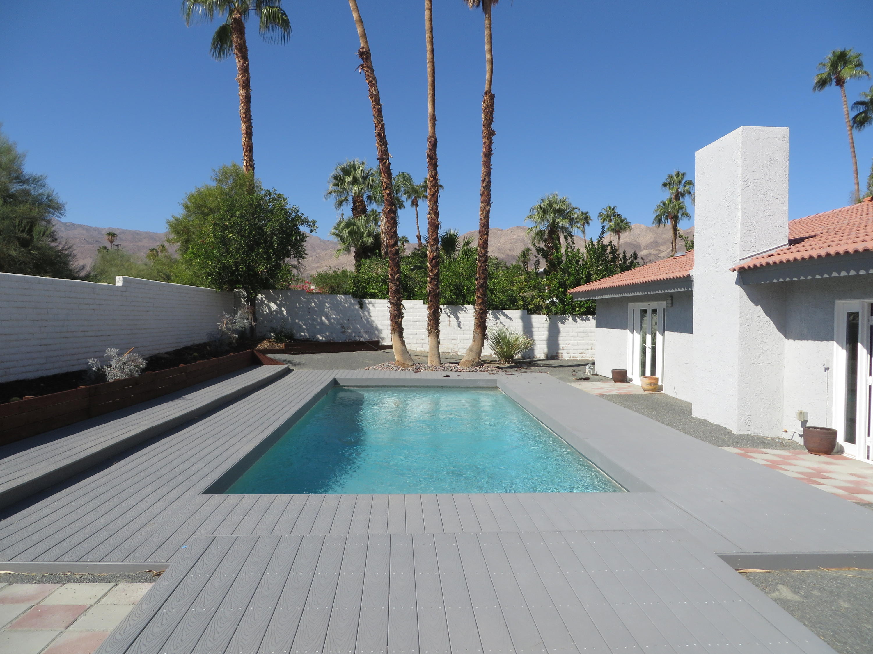 73315 Haystack Road Palm Desert, CA 92260 - Photo 27 of 32 a view of a swimming pool with a chairs