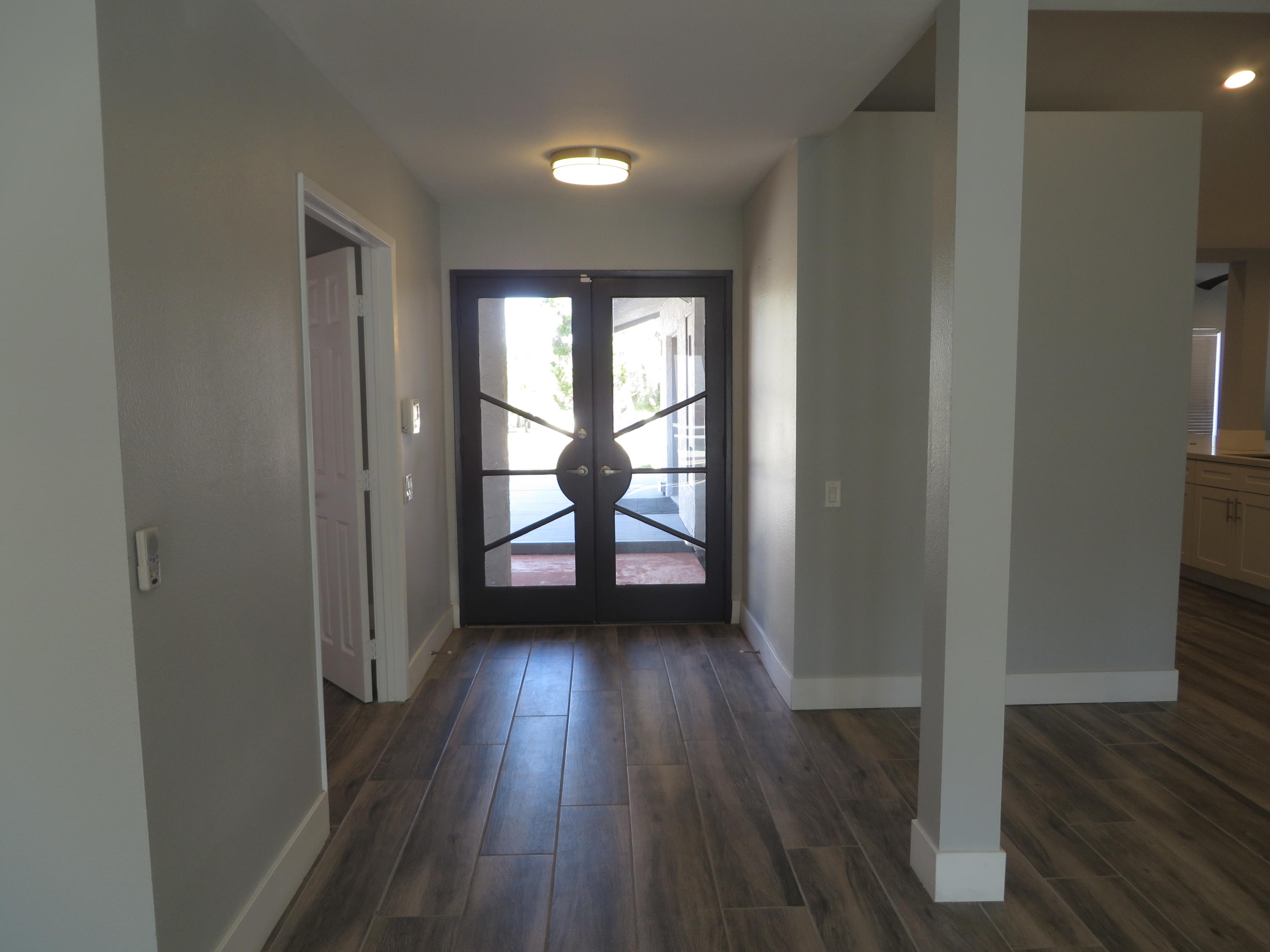 73315 Haystack Road Palm Desert, CA 92260 - Photo 5 of 32 wooden floor in an empty room with a window
