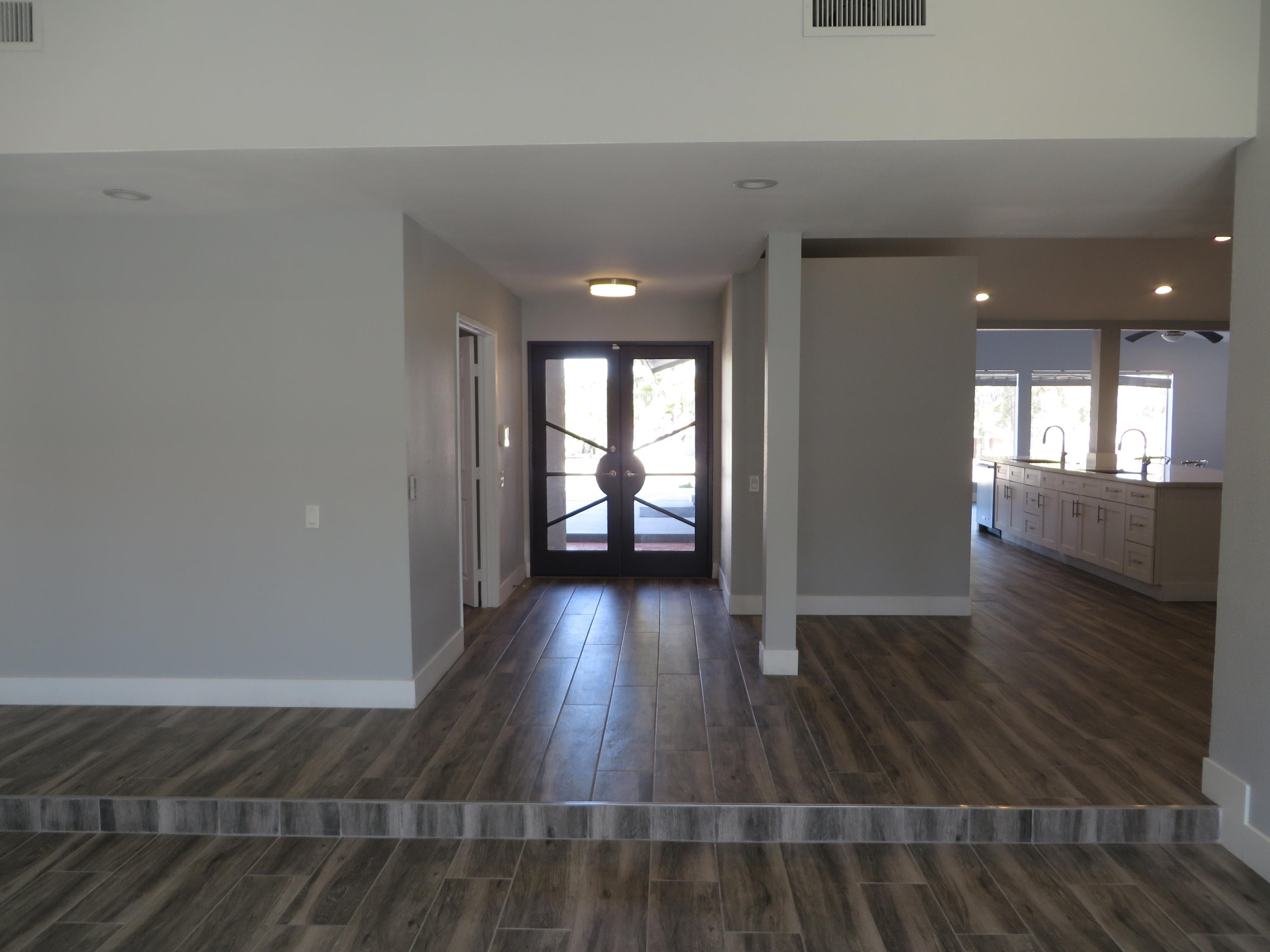 73315 Haystack Road Palm Desert, CA 92260 - Photo 6 of 32 wooden floor in an empty room with a window