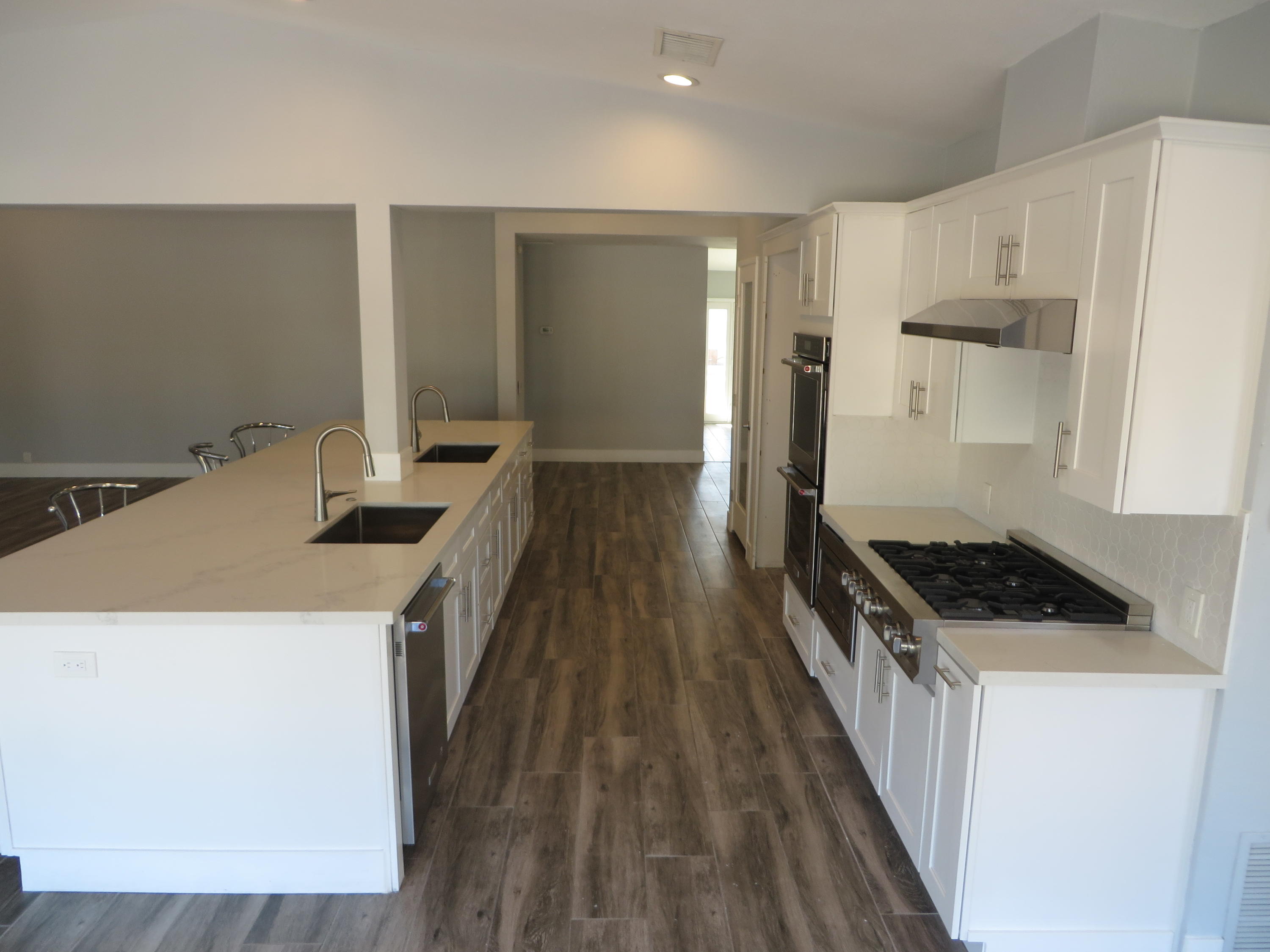 73315 Haystack Road Palm Desert, CA 92260 - Photo 10 of 32 a kitchen with granite countertop a sink a stove and refrigerator