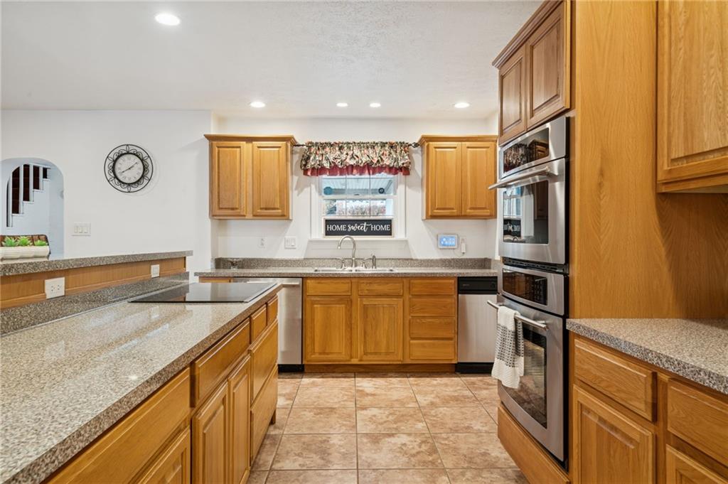 1619 Kennedy Road Imperial, PA 15126 - Photo 11 of 40 a kitchen with stainless steel appliances granite countertop a sink stove and refrigerator