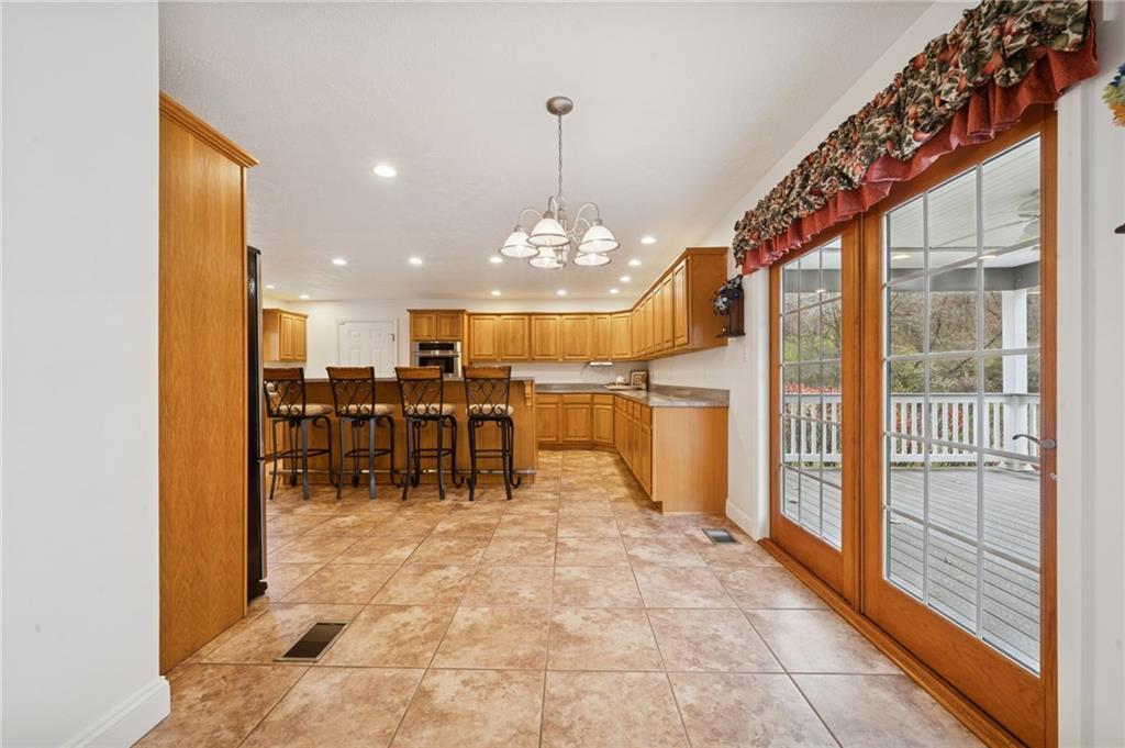 1619 Kennedy Road Imperial, PA 15126 - Photo 13 of 40 a view of a dining room with furniture a chandelier and a large window